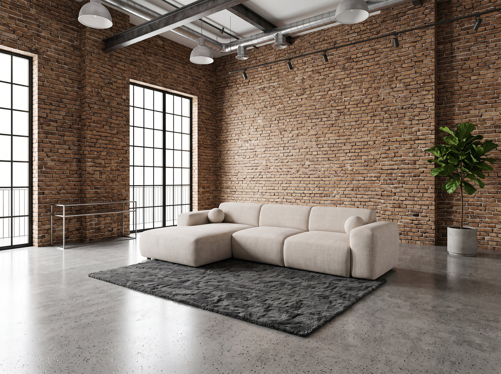 Canapé d'angle Galet dans un loft industriel briques